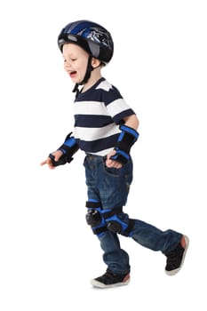 Little boy in protection helmet and in the knee and arm ruffles runs and laughs Isolated on white background