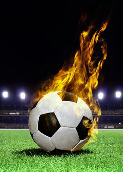 fiery soccer ball on playing field of stadium