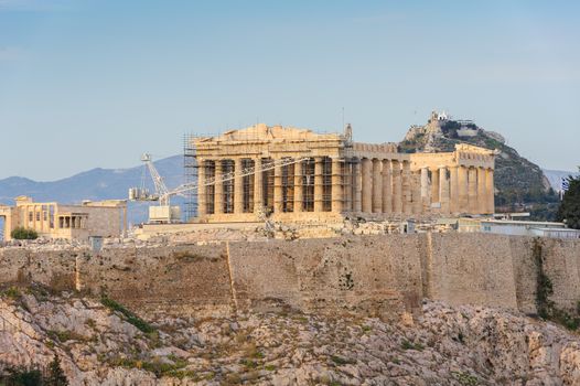 Ancient Acropolis in rays of sunset. Athens Greece. Copyspace.