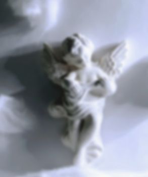 white angel figurine blurred