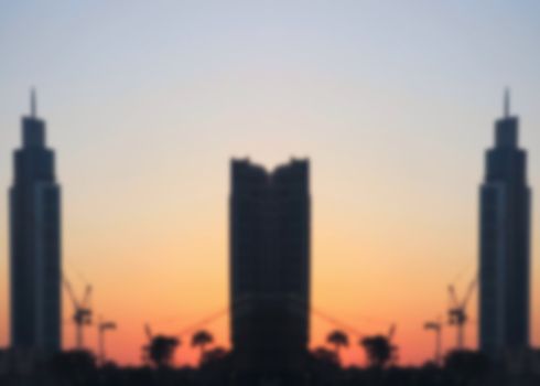 skyscrapers at sunset, the development of construction technologies, new technologies in architecture and construction of buildings, blurred
