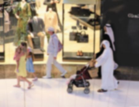 Arab sheikhs man in a mall make a purchase, Dubai, people go to the mall, market, blurred for background