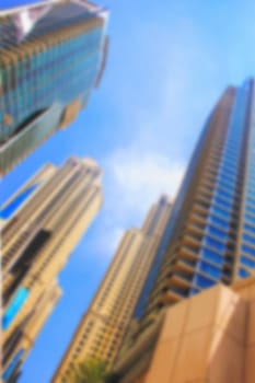 blurred  skyscrapers high rise buildings view from below against the blue sky modern architecture soft focus