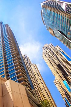 skyscrapers, tall buildings and buildings, view from below, the Emirates, Dubai, on fonegoluboe sky modern architecture