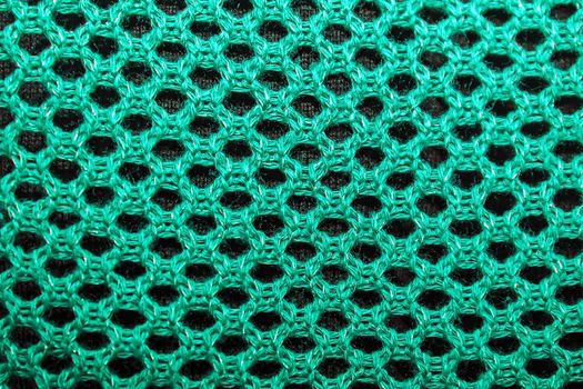texture of knitted fabric, openwork knit, knitted fabrics of cotton yarn as background.