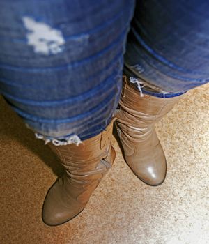 female legs in brown boots, women's shoes, heels, Soft focus