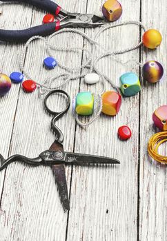 chain,pair of scissors and set of beads for jewelry