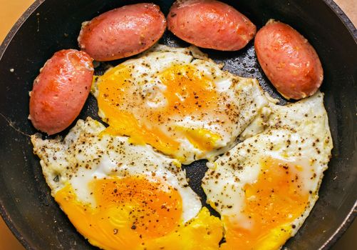 Fried eggs with sausage, bacon, breakfast, soft focus