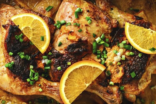 Background of baked chicken in oranges and spices