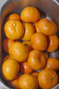 tangerines washed, Wash fresh mandarins in retro colander