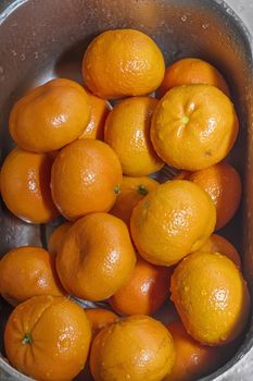 tangerines washed, Wash fresh mandarins in retro colander
