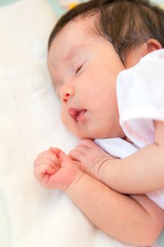 Peaceful sleeping baby lying on a bed