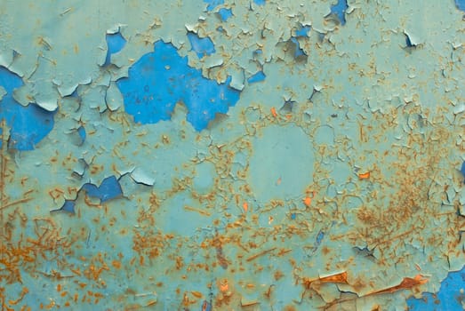 fragment of an iron surface is covered with paint, which has long been under the influence of different climatic conditions