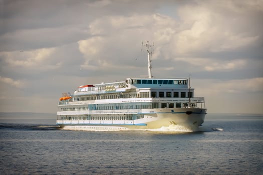 Cruise ship in open water front view