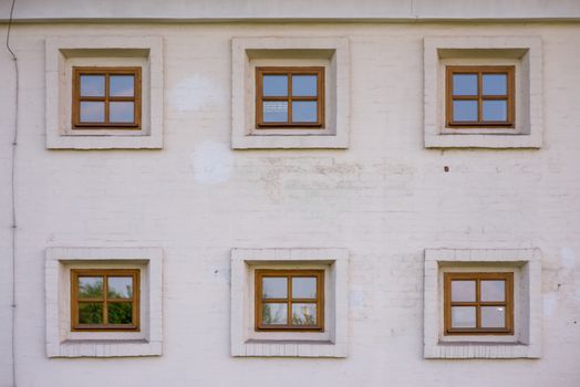 vintage brick wall background with six old windows.