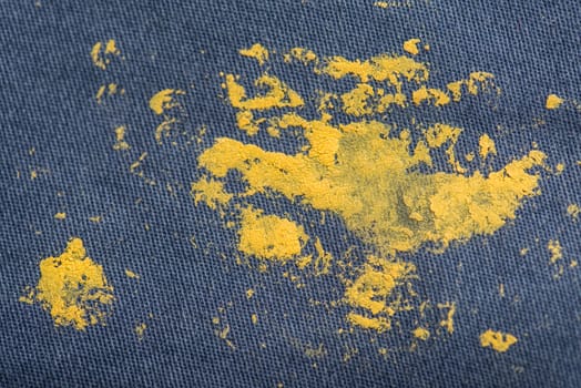 Blue Jeans and sneakers stained with yellow paint