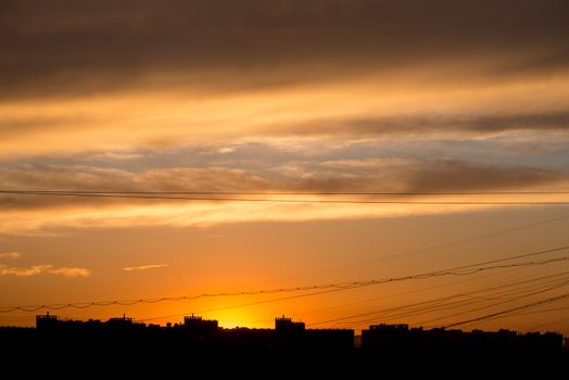 Natural background of  colorful red sky during  sunset time with street roofs.