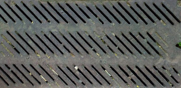 Close up shot of a rusty old vintage drain grate