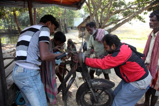 Mechanic repair the motorbike. Bikes is the common individual transport in India.