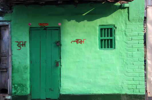 Colorful Indian house. Bright green building in Kolkata, West Bengal, India on February 23, 2012.