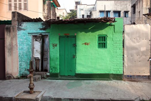 Colorful Indian house. Bright green building in Kolkata, West Bengal, India on February 23, 2012.