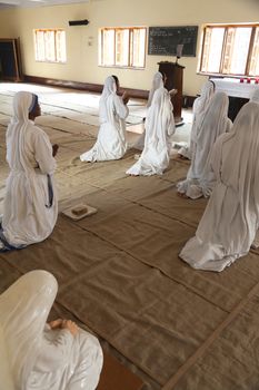 Sisters of Mother Teresa's Missionaries of Charity in prayer in the chapel of the Mother House, Kolkata, India at February 08, 2014.