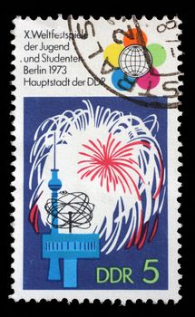 Stamp printed in GDR shows Festival Emblem, Fireworks, TV Tower, World Clock, 10th Festival of Youths and Students, Berlin, circa 1973