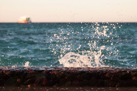 Photo closeup of beautiful clear turquoise sea ocean water surface with ripples and bright splash on seascape background, horizontal picture.