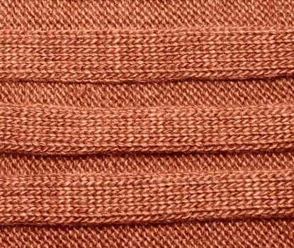 Brown ribbed knit wool like texture, textured fabrics knitted jersey, wool as a background pattern, upholstery