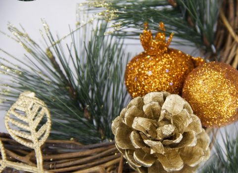Christmas wreath with pine cones and gold ornaments Christmas decoration of the Christmas tree blurred