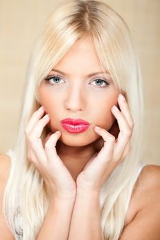 Portrait of young beautiful blond hair girl with red lipstick