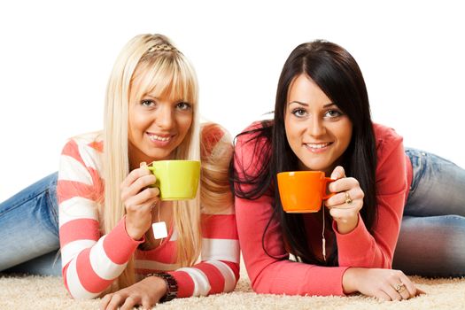 Beautiful girls drink tea and enjoying at home