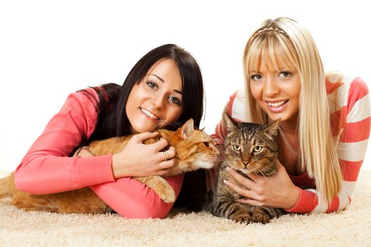 Beautiful girls with domestic cat enjoying at home
