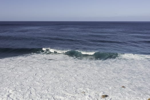 Waves breaking on the shore of Madeira island on Portugal coast mear Sao Vincence