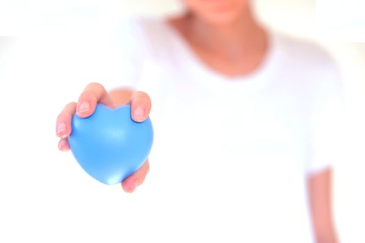 people, relationship and love concept - close up of womans cupped hands showing red heart