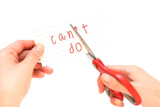 Female using scissors to remove the word can't to read I can do it concept for self belief, positive attitude and motivation