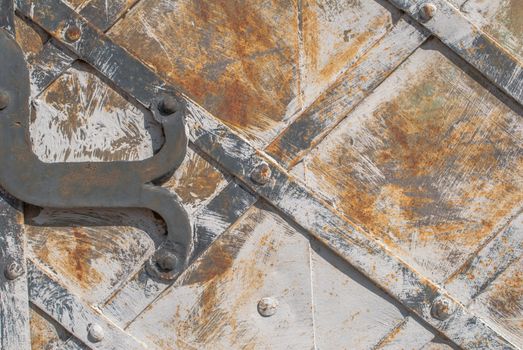 rusty iron surface covered with old chipped paint, which has long been influenced by different climatic conditions