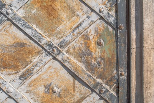 rusty iron surface covered with old chipped paint, which has long been influenced by different climatic conditions