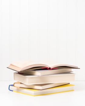 Small stack of hardcover books with ample copy space.