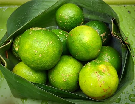 Close Up Of Fresh Limes In Banana Leaf Packaging