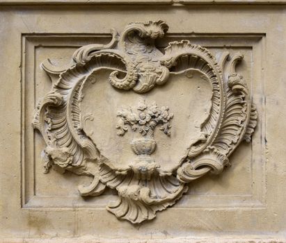 Straight on close up of elegant old classical style stone relief with decoration in rectangle