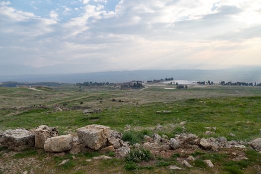 View of Hyerapolis Ancient City with stone ruins on cloudy sky background.
