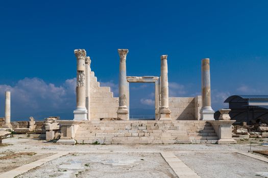 View of historical ancient city of Laodicea in Denizli with high columns on bright blue sky background.