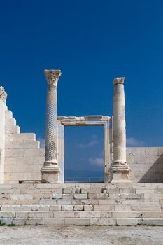 View of historical ancient city of Laodicea in Denizli with high columns on bright blue sky background.