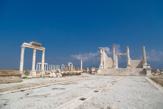 View of historical ancient city of Laodicea in Denizli with high columns on bright blue sky background.