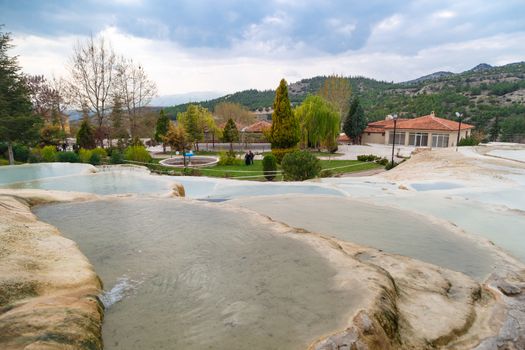 View of natural geographical formations in Pamukkale area in Turkey with travertine pools.