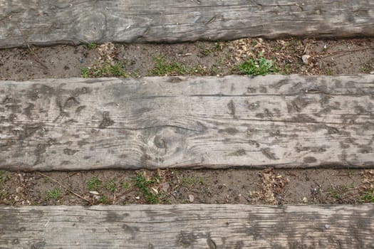 Close up detailed view of a wooden pathway in a park.