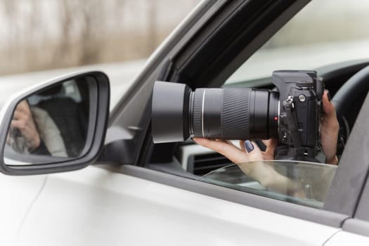 a girl takes pictures from a car window