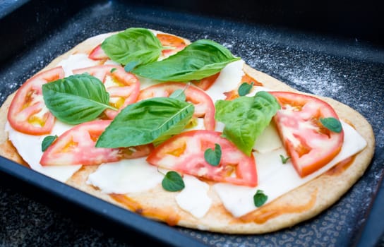 Unbaked margherita pizza