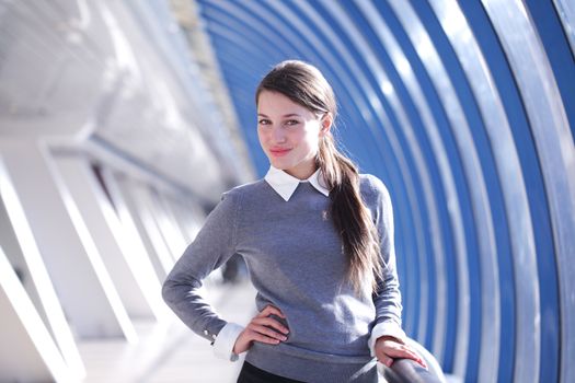 Young Businesswoman standing in corridor of modern office building